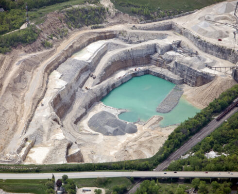 Aerial view of a large quarry and rock crushing operation.